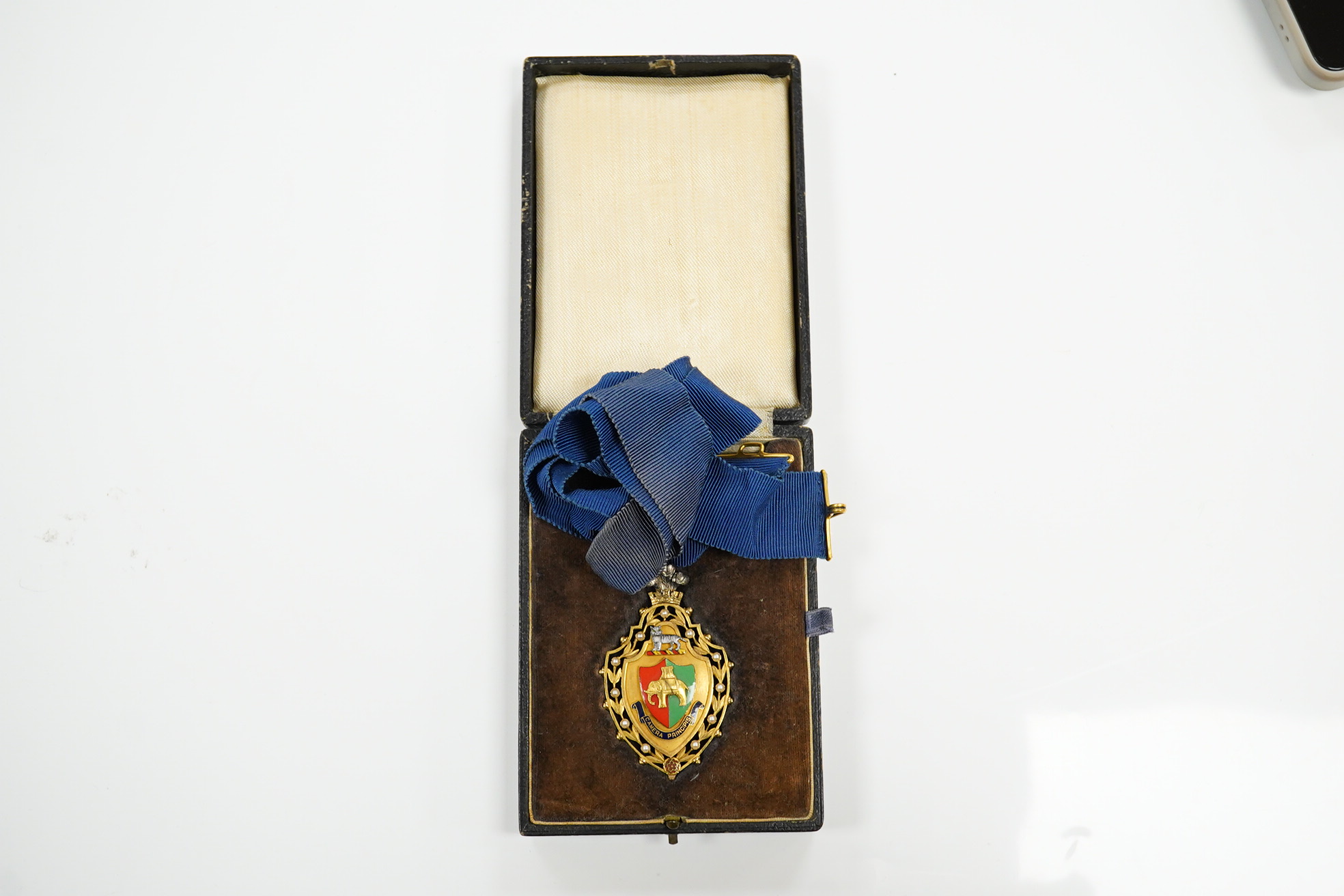 A cased 9ct enamelled gold medal, awarded to Lily L. Gordon Mayoress of Coventry 1945 to 1946, Presented by the Corporation, 10th November 1947. Condition fair to good, some wear and fading to ribbon and case, etc.